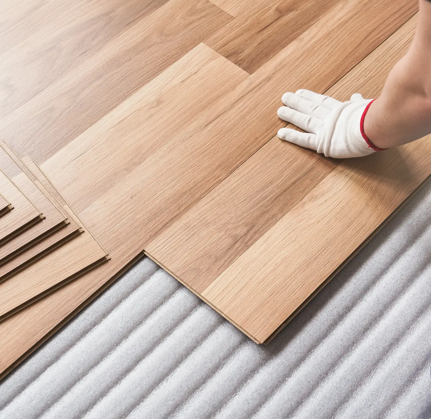 Flooring professional installing hardwood flooring